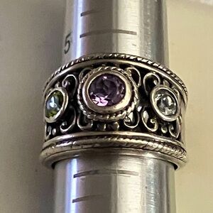 Vintage amethyst and aquam gem in elaborate sterling silver setting.